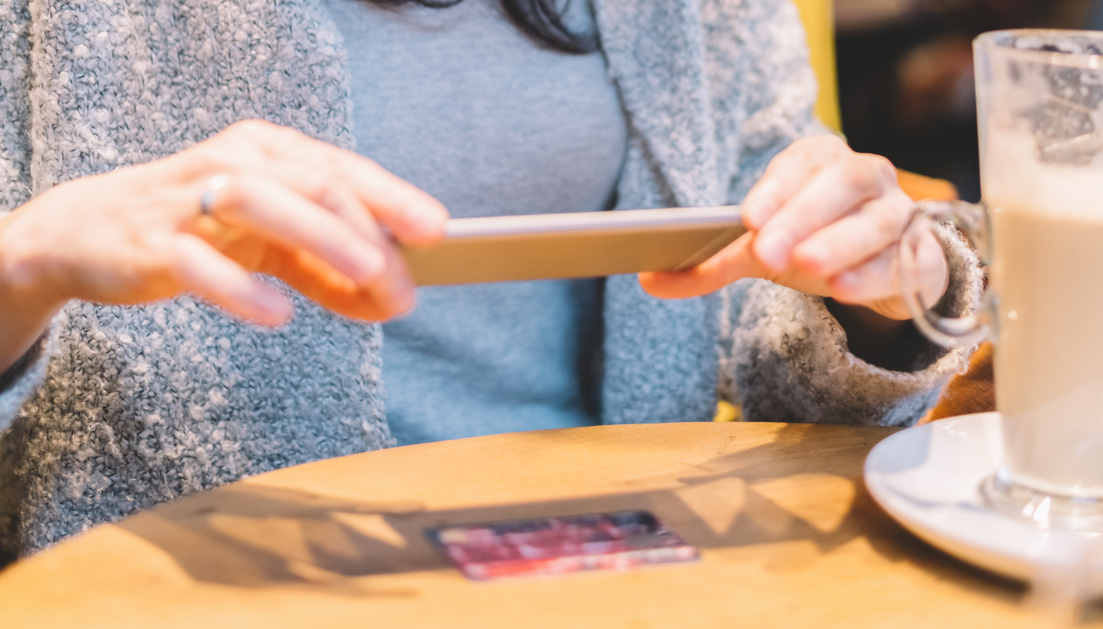 Phone photographing a business card with a scan frame on screen